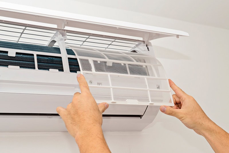 Technician fixing a ductless unit