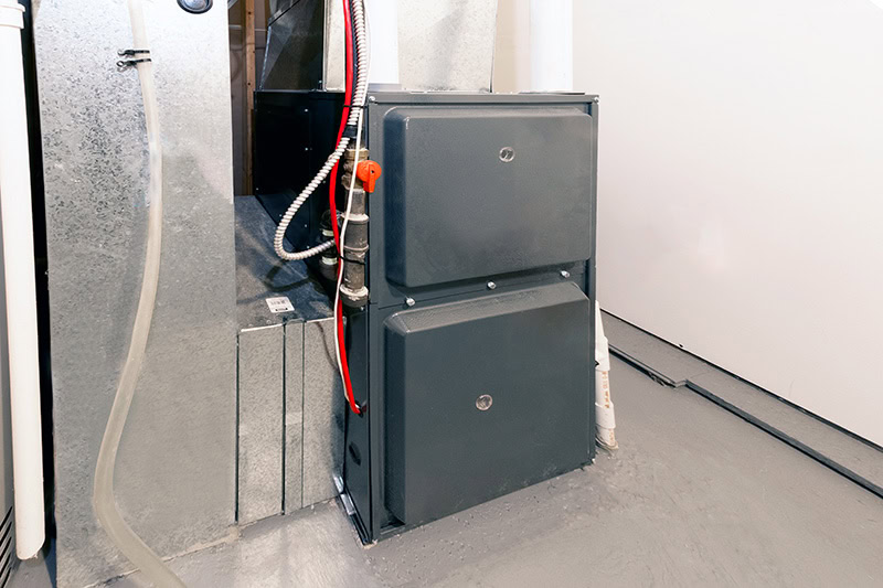 A residential HVAC furnace unit installed in a utility space or basement.