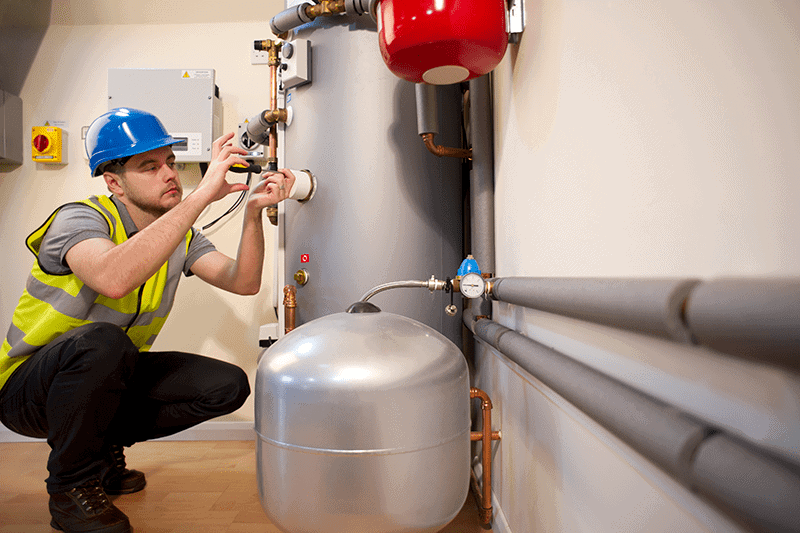 7 Furnace Maintenance Tips. Image of furnace being serviced.